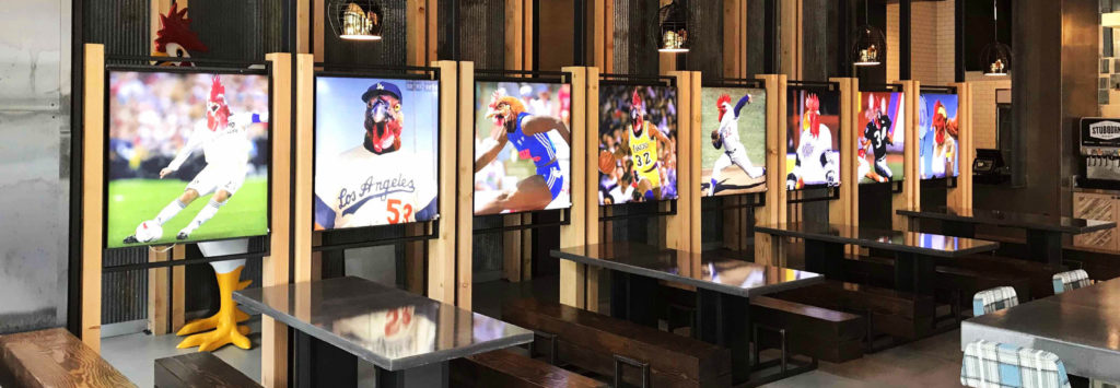 Fabric Backlit color graphics showing famous athletes with rooster heads photoshopped over their heads for Crack Shack Restaurant