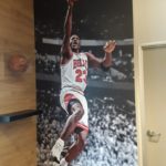 Conference room wall mural of Michael Jordan next to signed ball