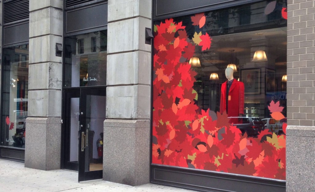 Red leaf window cling cutouts arranged in clothing store window display