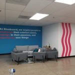 Bold primary blues and red show company identity on wall mural installation