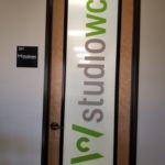 Custom printed Window film with white background and color-matched logo for Studio WC architectural firm