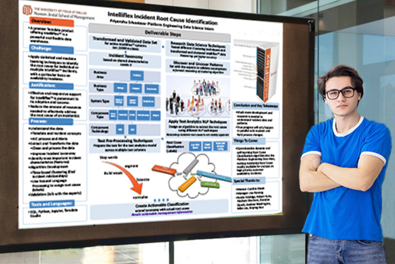 young male student standing next to scientific poster on bulletin board.