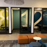 Single Floor-to-ceiling Vinyl numeral in adjacent offices on different colored backgrounds provide unique identify
