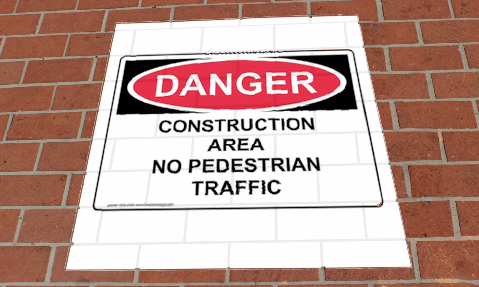 Floor Graphic sign, "danger construction area," on red brick walkway