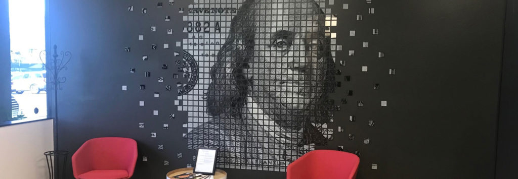 Acrylic wall mosaic made up of hundreds of 4 inch squares showing Benjamin Franklin on an enlarged 100 dollar bill