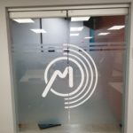white logo printed on Frosted effect privcy film installed on Gleim Conference Center entry doors.