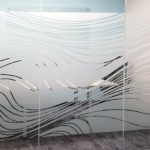Abstract meandering wavy clear lines on frosted privacy window film installed on conference room interior window