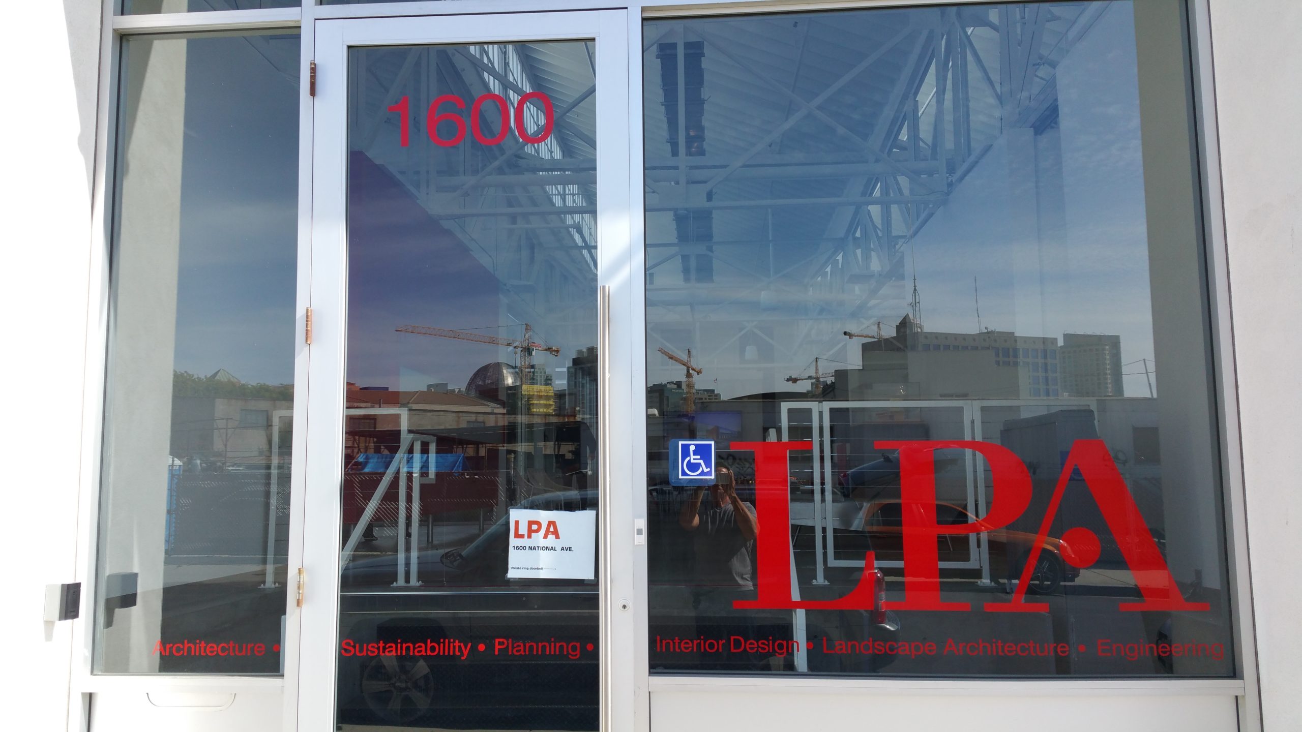 Bright red letters printed on window cling in front window of LPA architects