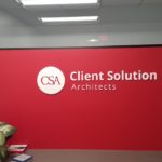 Interior office bright red wall with white acrylic logo and company identity.