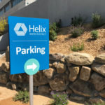 Helix Water District parking sign showing logo, identity and wayfinding arrow pointing right.