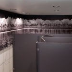 Wall Mural in Sepia tones of Oasis and white clouds in restroom for Monarch Grill