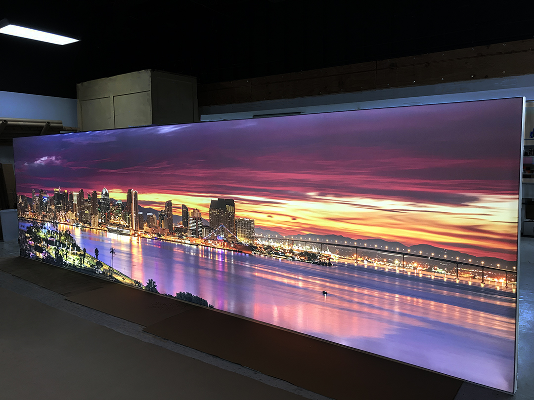 Backlit 22 foot long mural of vivid San Diego Sunrise over Downtown and the bay