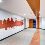 parking orange level entrance from 655 Gym in downtown San Diego denoted by large orange wall mural and wide painted ceiling stripe